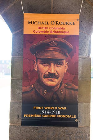 Michael O’Rourke was awarded the Victoria Cross for his actions as a stretcher-bearer at the Battle of Hill 70 during the First World War. His portrait appears on Toll of War banners in B.C. Portrait by Sharif Tarabay.