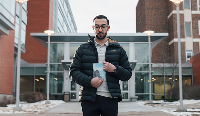 Daniel Ghods-Esfahani holds a photo of his girlfriend picture 2