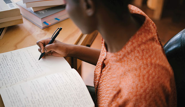 girl writing on notebook