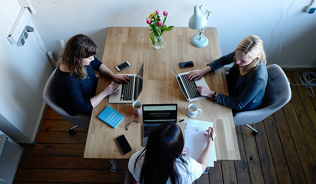 Girls working on laptop in office