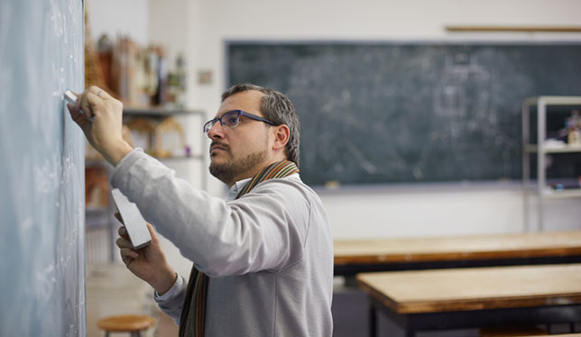 teacher writing on black board