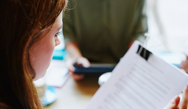 girl looking at paper