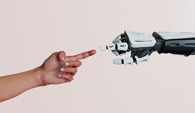 Human finger touching a robot finger.