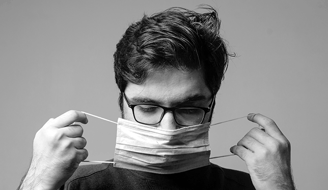 Man taking off a mask.