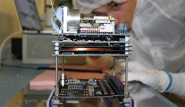 A student works on the University of Alberta’s first CubeSat project, Ex-Alta 1. Photo courtesy of University of Alberta.