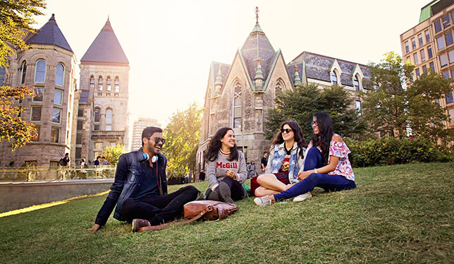 3 girls and boy sitting on grass