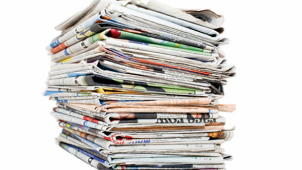 Stacked newspapers on a white background