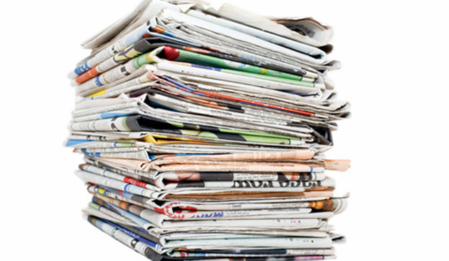 Stacked newspapers on a white background