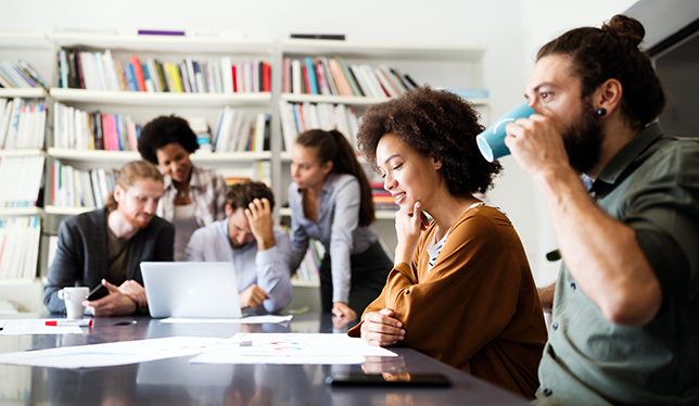 A group of business people talking around a table.